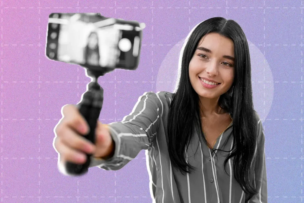 Photo of a woman vlogging with her phone using the best mobile videography techniques.