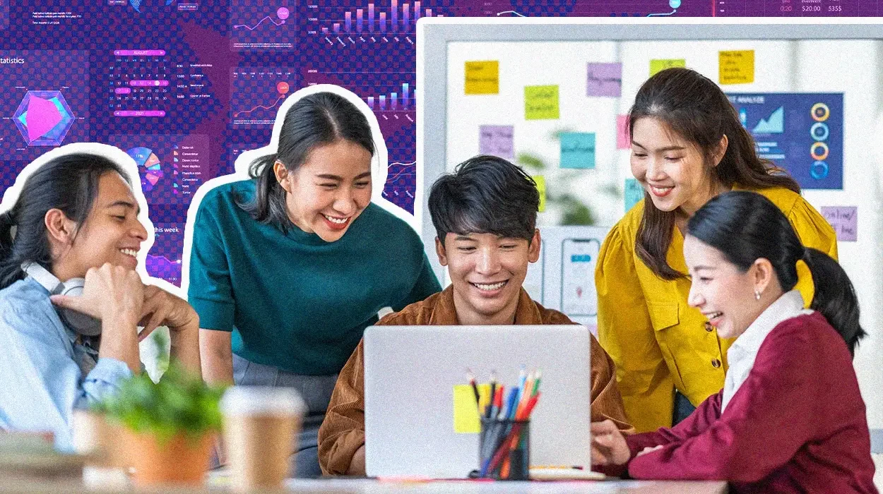 Group of young professionals collaborating around a laptop, smiling and discussing data visualization displayed on a digital board in the background.