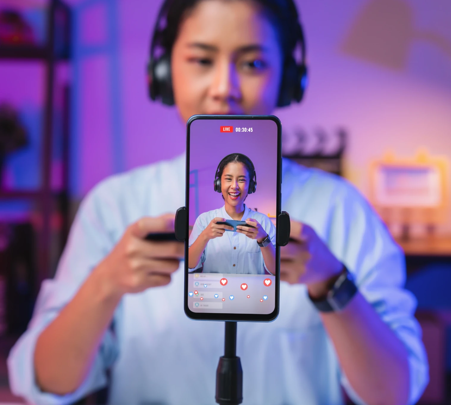 Content creator using smartphone for social media, demonstrating influencer management services