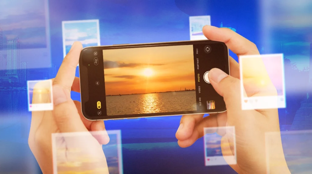 Hands holding smartphone capturing Manila Bay sunset, illustrating best sunset spots in Manila